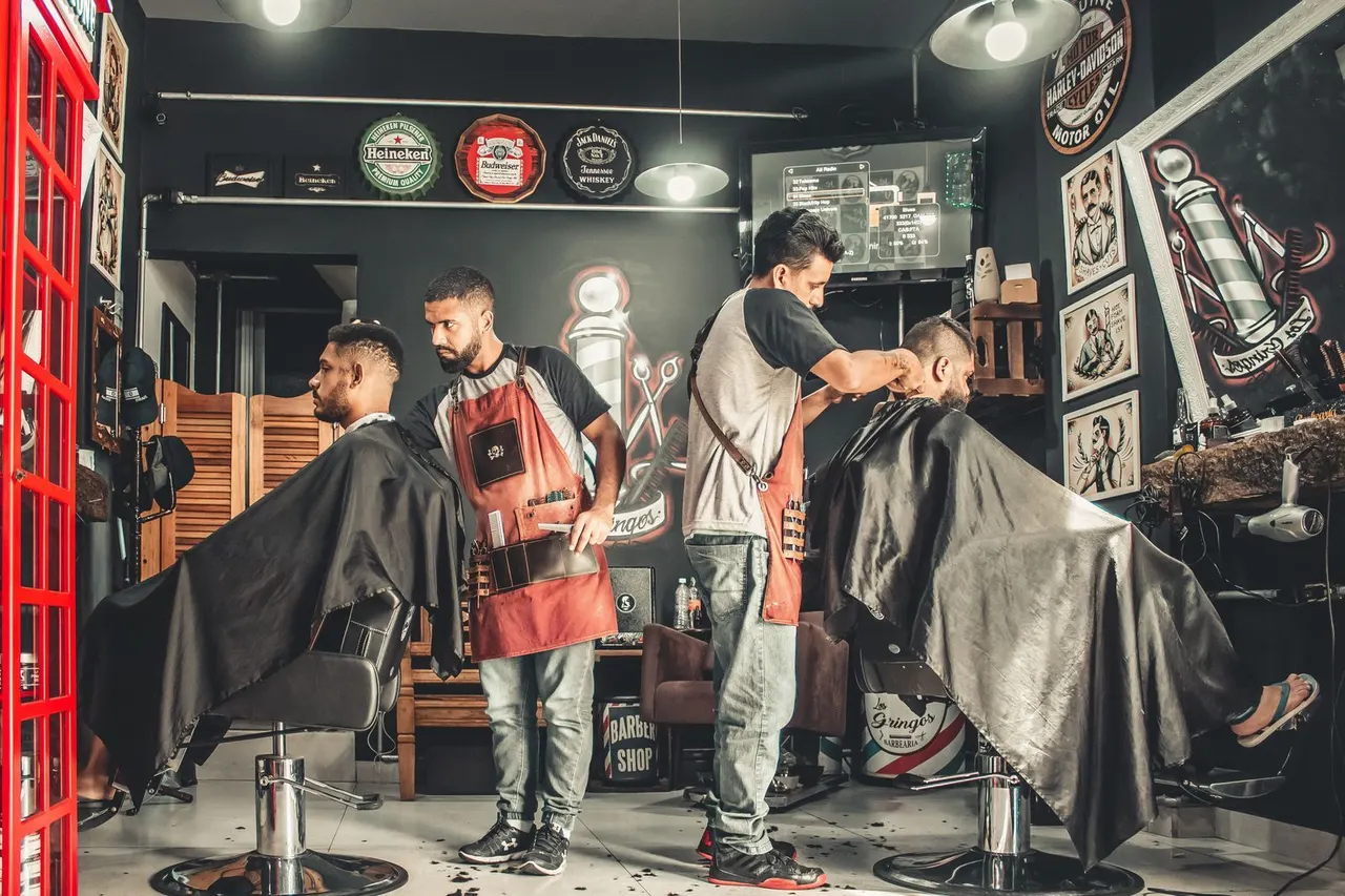 Two barbers at work in a classic neighborhood barbershop
